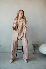 Naklejka premium Nice girl in pantsuit at concrete wall.