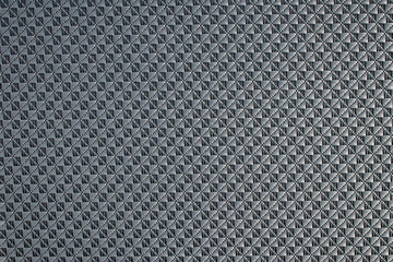 Close up of gray synthetic textured fabric with a rhombus pattern used to make blinds. Template design or polyester material abstract background.