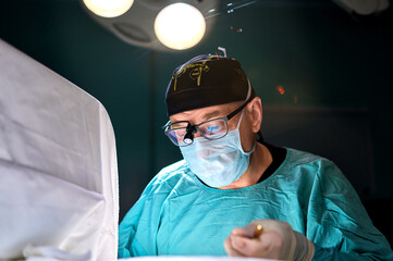 surgeon in a dark operating room during surgery