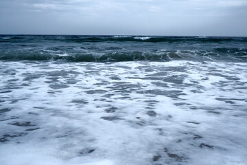 Landscape of blue ocean waves with beautiful clouds.