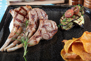 Turkish Cuisine Lamb Chops. Grilled Lamb Chops. Roasted ribs on creative restaurant floor. Lamb Ribs with Spices and Sauce.