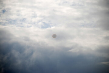 Large soap bubbles in the air. Against the background of a cloudy white sky, large rounded soap...