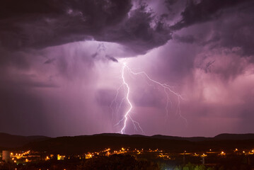 Storm Clouds and Lightning Bolts near the City