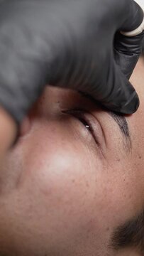 Close up shot of male microblading procedure