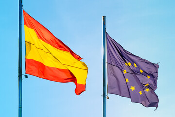 Flags of spain and eu european union against the sky