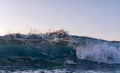 Low angle of a breaking wave in front of the camera