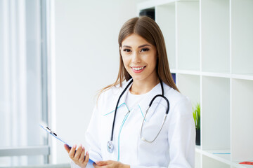 Medical beautiful female doctor in white coat with stethoscope.