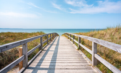 Fototapeta na wymiar Wooden walkway at the beach in summer