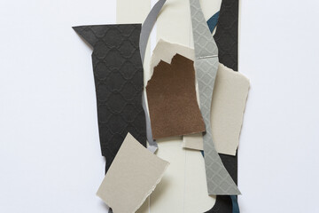 paper scraps on a flat paper surface (black, brown, gray)