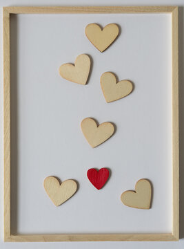 wooden hearts (one painted red) inside a wood frame
