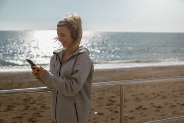 Good looking young woman standing near coastline