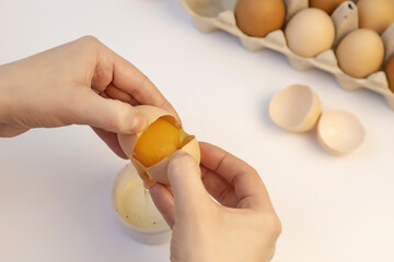 The process of separating the yolk from the protein. Tray of chicken eggs