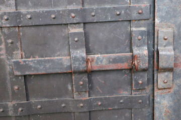an iron black old rusty door with a lock. lock door    