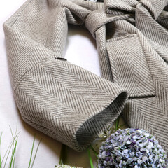 Stylish women's outfit, gray autumn coat on a white background. Close-up