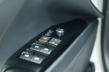 The buttons of the front and rear power windows - lower or close the windows of the car. Door locking buttons. Adjustable folding mirrors left and right. Close-up