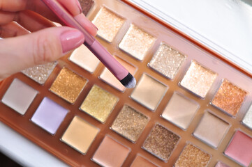 Woman hold make up brushes and shades