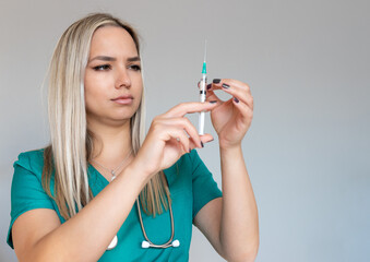 Female doctor or nurse holding syringe with injection and medicine. - obrazy, fototapety, plakaty