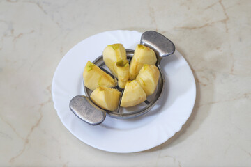 Peeled apple sliced with six blade metal corer cutter