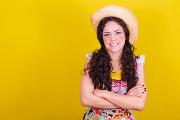 Beautiful woman dressed in typical clothes for a Festa Junina. With arms crossed smiling