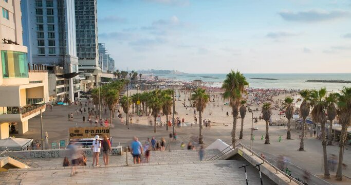 Time lapse of people walking at Tel Aviv Boardwalk, with the mediterranean sea at the background, israel