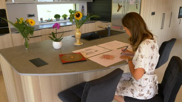 CLOSE UP: Female feng shui practitioner analysing feng shui energy distribution. Young woman making a feng shui plan for balanced home, good harmony and efficient house interior design arrangement.