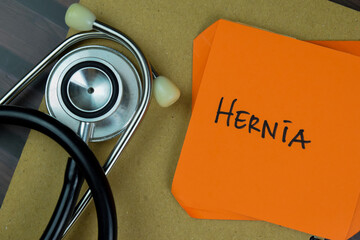 Concept of Hernia write on sticky notes isolated on Wooden Table.