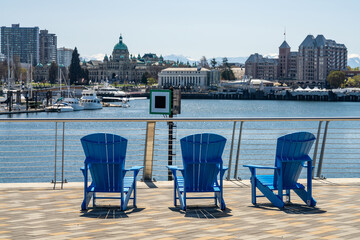 Adirondack chairs and Historical buildings. Victoria, Vancouver Island, Canada. West Bridge Plaza...