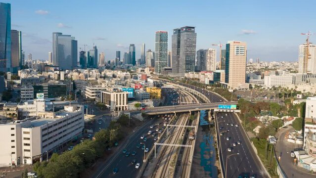 hyperlapse of tel aviv skyline with urban skyscrapers, busy traffic on ayalon highway and beautiful moving clouds, Israel