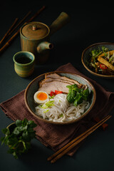 Asian noodle soup on table, ramen with pork, vegetables and egg in a bowl. Copy space - 507380830