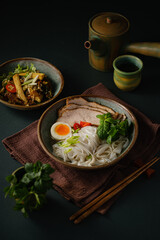 Asian noodle soup on table, ramen with pork, vegetables and egg in a bowl. Copy space - 507380872