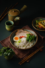 Asian noodle soup on table, ramen with pork, vegetables and egg in a bowl. Copy space - 507380891