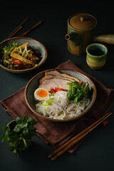 Asian noodle soup on table, ramen with pork, vegetables and egg in a bowl. Copy space - 507381010