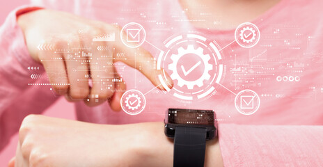 Quality control approval with woman pressing a smart watch