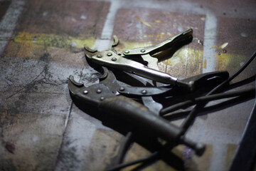 Clamps for supply of electricity to battery. Item in car repair shop. Parts of welding machine.