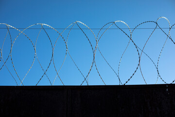 Barbed wire fence. Details of industrial area.
