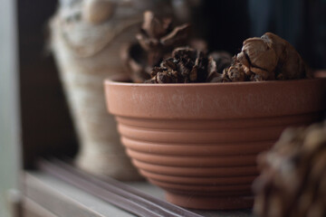 Cruse. Things on balcony. Old vase. Item on shelf.