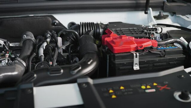 Car engine under the hood of a modern car. New car in the showroom.