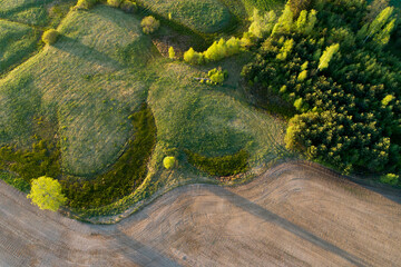 An aerial of a mosaic rural landscape with fields and bushes