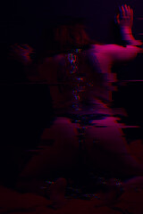 Girl with a tattoo is kneeling with a chain around her neck, image with glitch effect