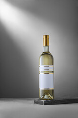 Bottle of white dry varietal wine from German Riesling grape sort on wooden backdrop with blank label, no brand template, mockup. Vertical shot