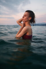 Fototapeta na wymiar Beautiful lady is posing in the sea.