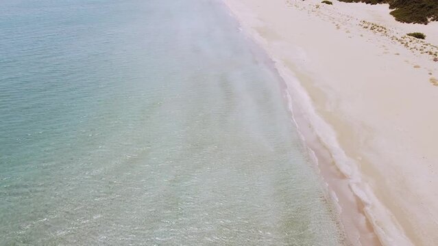 Aerial drone. Beautiful crystal clear water and sandy beach. Cittadella dei Maccari, San Lorenzo, Nature Reserve Oasis of Vendicari, Sicily. Idyllic holiday destination near Noto and Marzamemi.