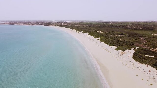 Aerial drone. Beautiful crystal clear water and sandy beach. Cittadella dei Maccari, San Lorenzo, Nature Reserve Oasis of Vendicari, Sicily. Idyllic holiday destination near Noto and Marzamemi.