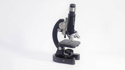 old analog microscope, mirror on white background with copy space