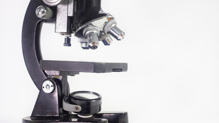old analog microscope, mirror on white background with copy space