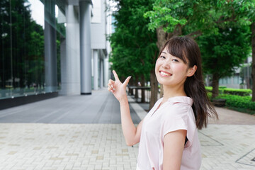 Young woman pointing on street