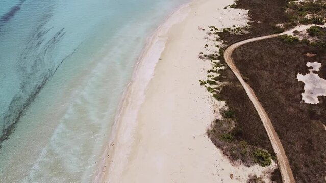 Aerial drone. Beautiful crystal clear water and sandy beach. Cittadella dei Maccari, San Lorenzo, Nature Reserve Oasis of Vendicari, Sicily. Idyllic holiday destination near Noto and Marzamemi.