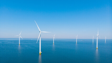 Windmill park in the ocean, drone aerial view of windmill turbines generating green energy...