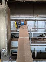 Malaysia, 25 May 2022: A blue palm kernel intake conveyor motor located in a palm kernel processing plant.