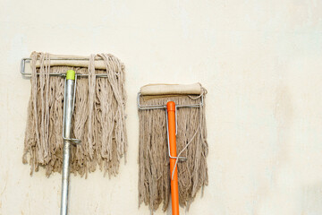 Mop next to the wall of the house
